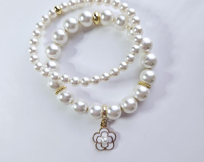 White Austrian crystal flower power pearl bracelet duo with enamel and gold plated flower charm.