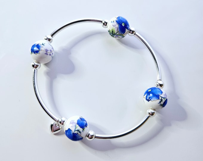 Truly Blessed, count those blessings bracelet with white porcelain beads with hand painted electric blue floral design and silver charm.