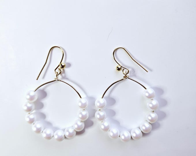 Hoop earrings with pearlescent white pearls and 14kt gold filled earring wire.