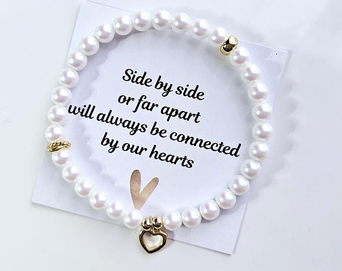 Connected by our hearts bracelets are made with Austrian crystal pearlescent white pearls and 14kt gold filled heart charm.
