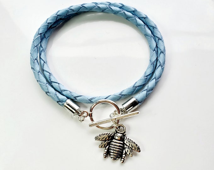Silver Bumblebee leather wrap charm bracelet on braided aqua blue leather with toggle clasp.