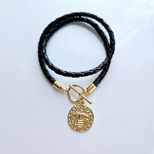 Gold queen bee leather wrap charm bracelet with gold toggle clasp.