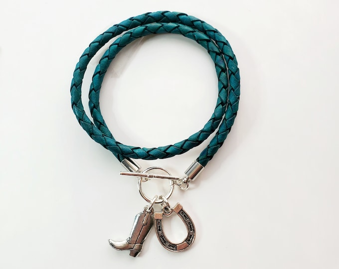 Silver Cowboy boot leather wrap charm bracelet on braided green leather with toggle clasp.
