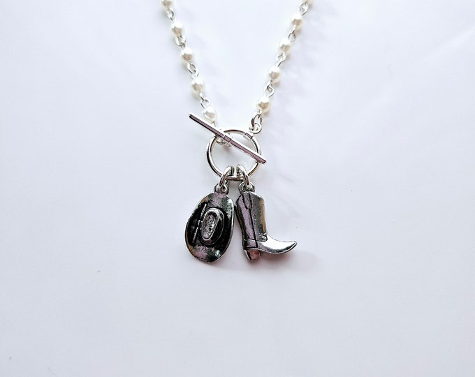 Cowboy boot and hat charm necklace on pearl rosary bead chain.