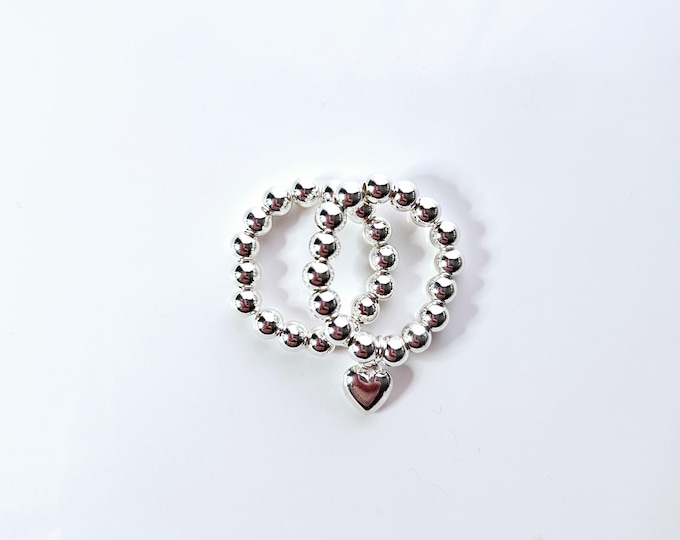 Sterling silver bead stackable ring with sterling silver heart charm.