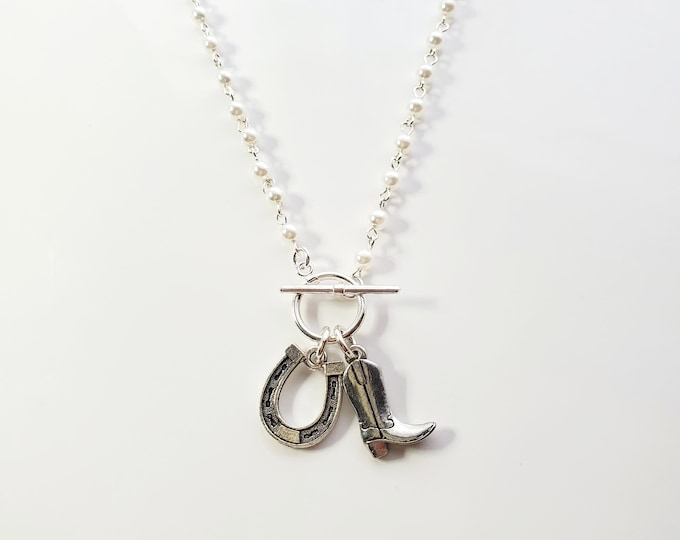 Cowboy boot and horseshoe charm necklace on rosary bead chain