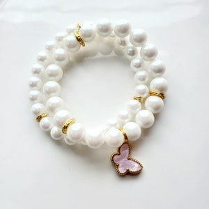 White pearlized Preciosa pearl bracelet set with soft pink Mother of pearl butterfly charm.