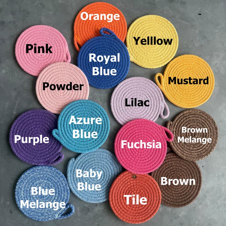 May include: A collection of round, coiled rope coasters in various colors, each labeled with text including Pink, Orange, Yelllow, Royal Blue, Powder, Mustard, Lilac, Purple, Azure Blue, Fuchsia, Brown Melange, Blue Melange, Baby Blue, Tile, and Brown.