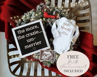 May include: A white onesie with the text "BABY Hewitt DUE JUNE 2025" in brown lettering. A red cardinal figurine, a Christmas wreath, a black letter board with the text "the more, the crazie... um-merrier", a black and white ultrasound image, and a white circle with the text "FREE Birth Announcement INCLUDED" in brown lettering are arranged in a wooden basket with a red blanket.