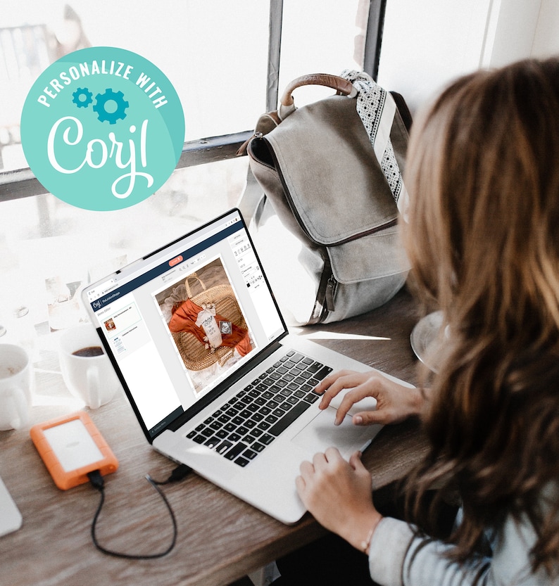 May include: A woman uses a laptop computer to design a graphic on a website. The laptop screen shows a design with a baby onesie and the text "Personalized with Corjl".