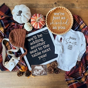 May include: A fall-themed pregnancy announcement with a pie that says "we're just as shocked as you", a letter board that says "we'll be adding another seat to the table next year", a baby onesie that says "Baby Smith Due June 2024", and a sonogram image.