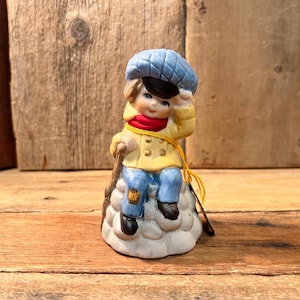 Jasco Merri-Bells Fine Bisque Porcelain Child Sitting on Rock with Blue Cap Figurine; c. 1978