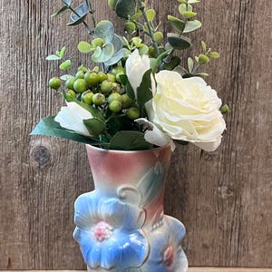 May include: A set of three ceramic mugs with a speckled, matte finish. The mugs are in shades of cream, light gray, and dark gray. Each mug has a simple, minimalist design, perfect for coffee or tea.