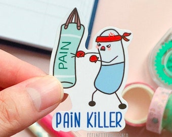 May include: A white sticker with a cartoon illustration of a blue pill punching a green punching bag that says "PAIN". The text "PAIN KILLER" is below the illustration.