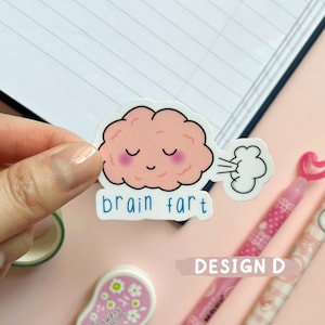 May include: A pink brain cartoon sticker with a cloud of smoke coming out of its mouth. The sticker says "brain fart" in blue text.
