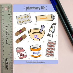 May include: A sticker sheet with a light blue background and the text "pharmacy life" in black. The sheet features various pharmacy-themed illustrations, including pills, bandages, a mortar and pestle, a syringe, and a tube of ointment.