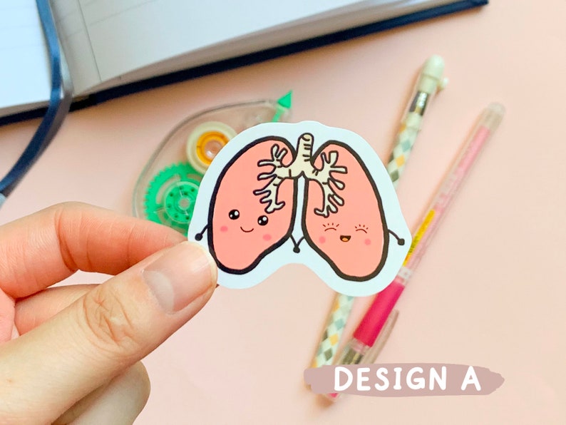 May include: A sticker of two pink cartoon lungs with smiling faces and black outlines. The lungs are holding hands and have a white bronchial tube connecting them. The sticker is on a pink background.