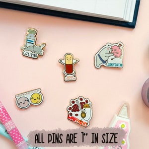 May include: A set of six enamel pins featuring humorous medical-themed illustrations. The pins are 1 inch in size and feature designs such as a cat with a bottle of medication, a pill with the text "Gimme Chillin", a person in a sumo wrestling outfit with the text "Sumotriptan", and a person with a red blob with the text "Warfarin".