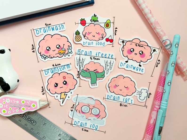 May include: Eight pink brain-shaped stickers with different expressions and text. The stickers are labeled with different brain-related terms, such as "brainwash", "brainstorm", "brain food", "brain freeze", "brainwave", "brain fart", and "brain fog".