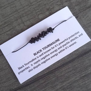 May include: Black Tourmaline bracelet with black string and black beads. "Black Tourmaline is well known for it's powerful protection properties. It repels negative energy and psychic attacks, and also dispels negative energy within it's wearer."