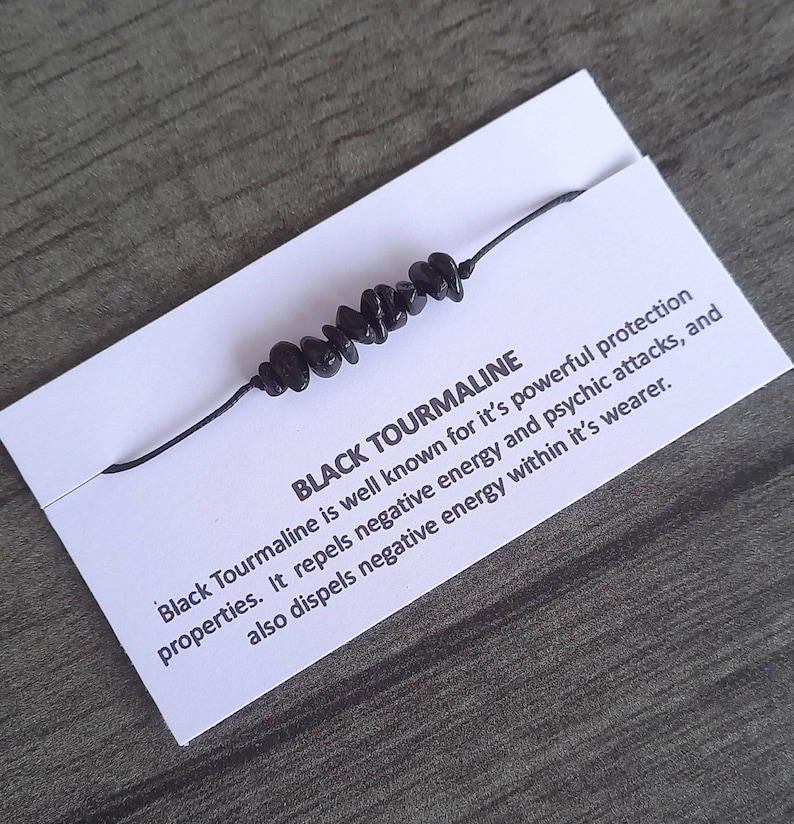 May include: Black Tourmaline bracelet with black string and black beads. "Black Tourmaline is well known for it's powerful protection properties. It repels negative energy and psychic attacks, and also dispels negative energy within it's wearer."