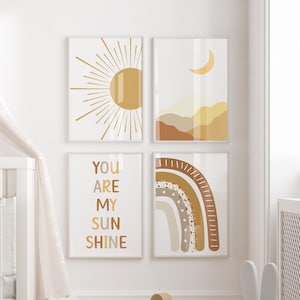 May include: A nursery room with a white cot, a rocking horse, and a white bunny toy. The walls are decorated with four prints featuring a sun, a moon, a rainbow, and the text "You are my sunshine".
