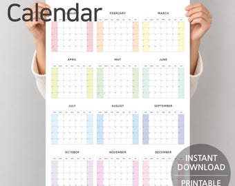 May include: A 2027 wall calendar featuring a twelve-month grid layout on a white background. Each month is organized with black text headers and pastel-colored columns for weekends. The design includes the text 2027 Calendar and Instant Download Printable PDF.
