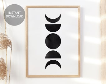 May include: A black and white print of the phases of the moon in a wooden frame. The moon phases are arranged vertically, starting with a crescent moon at the top and ending with a full moon in the middle.