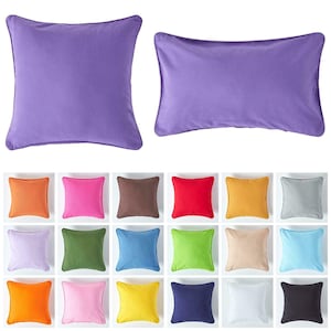 May include: A set of 18 square cushion covers in a variety of solid colours, including orange, pink, yellow, blue, green, brown, grey, and purple. The cushions are all the same size and have a subtle, light texture.