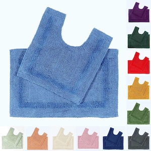 May include: A set of two bath mats in a variety of colors. The larger mat is rectangular and the smaller mat is shaped like a U. The mats are made of a soft, absorbent material.