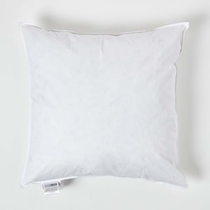 May include: A white pillow with a white fabric cover. The pillow is rectangular and has a label on the bottom corner that says "HOMECRAFT".