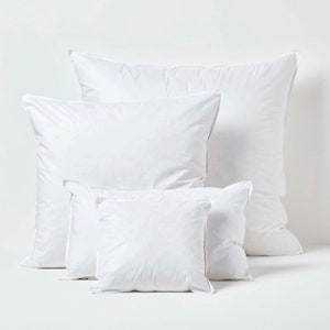 May include: Four white pillowcases of different sizes, arranged in a pyramid shape on a white background.