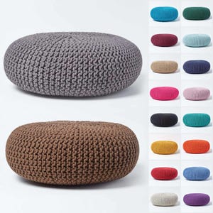 May include: Two round knitted poufs, one gray and one brown. The poufs are made of a thick, textured yarn and have a slightly irregular shape. They are perfect for adding a touch of bohemian style to any room.