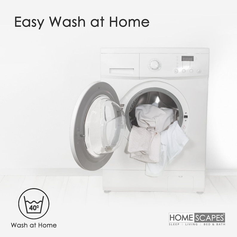 May include: A white washing machine with the door open, revealing white laundry inside. The machine has a digital display and a control panel. The text "Easy Wash at Home" is displayed above the machine. A washing instruction icon with a 40 degree symbol is displayed below the machine. The text "Wash at Home" is displayed below the icon. The text "HOME SCAPES SLEEP LIVING BED & BATH" is displayed below the machine.