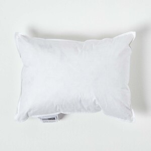 May include: A white pillow with a white label that says "Homescapes" on it.