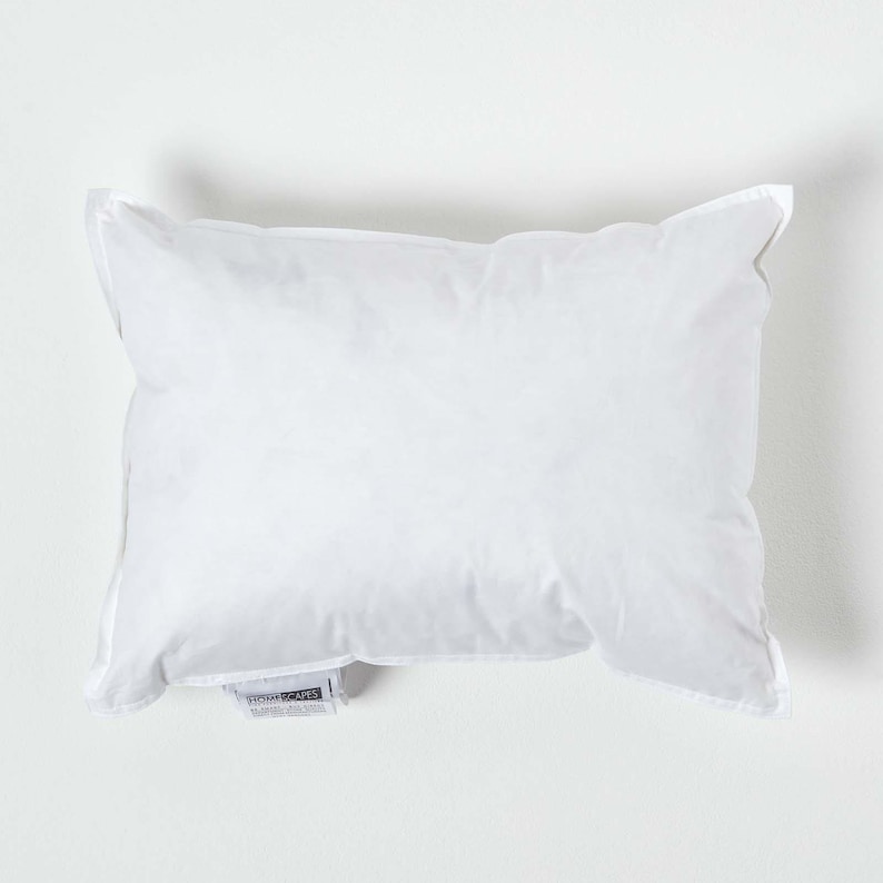 May include: A white pillow with a white label that says "Homescapes" on it.