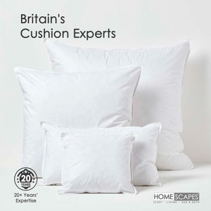 May include: A set of five white pillows of varying sizes, arranged in a pyramid shape. The pillows are made of a soft, fluffy material and have a smooth, white fabric cover. The pillows are arranged on a white background. The text "Britain's Cushion Experts" is displayed at the top of the image. A logo with the text "20 Years" is displayed at the bottom left of the image. The text "HOME SCAPES SLEEP LIVING BED & BATH" is displayed at the bottom right of the image.