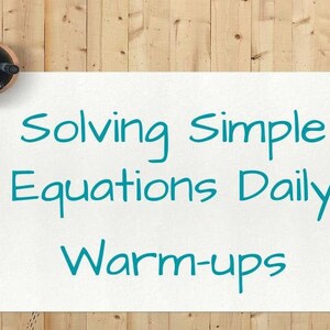 May include: A white sheet of paper with the text "Solving Simple Equations Daily Warm-ups" written in teal blue handwriting. The paper is on a wooden surface with a cup of coffee and a pencil holder with pencils.