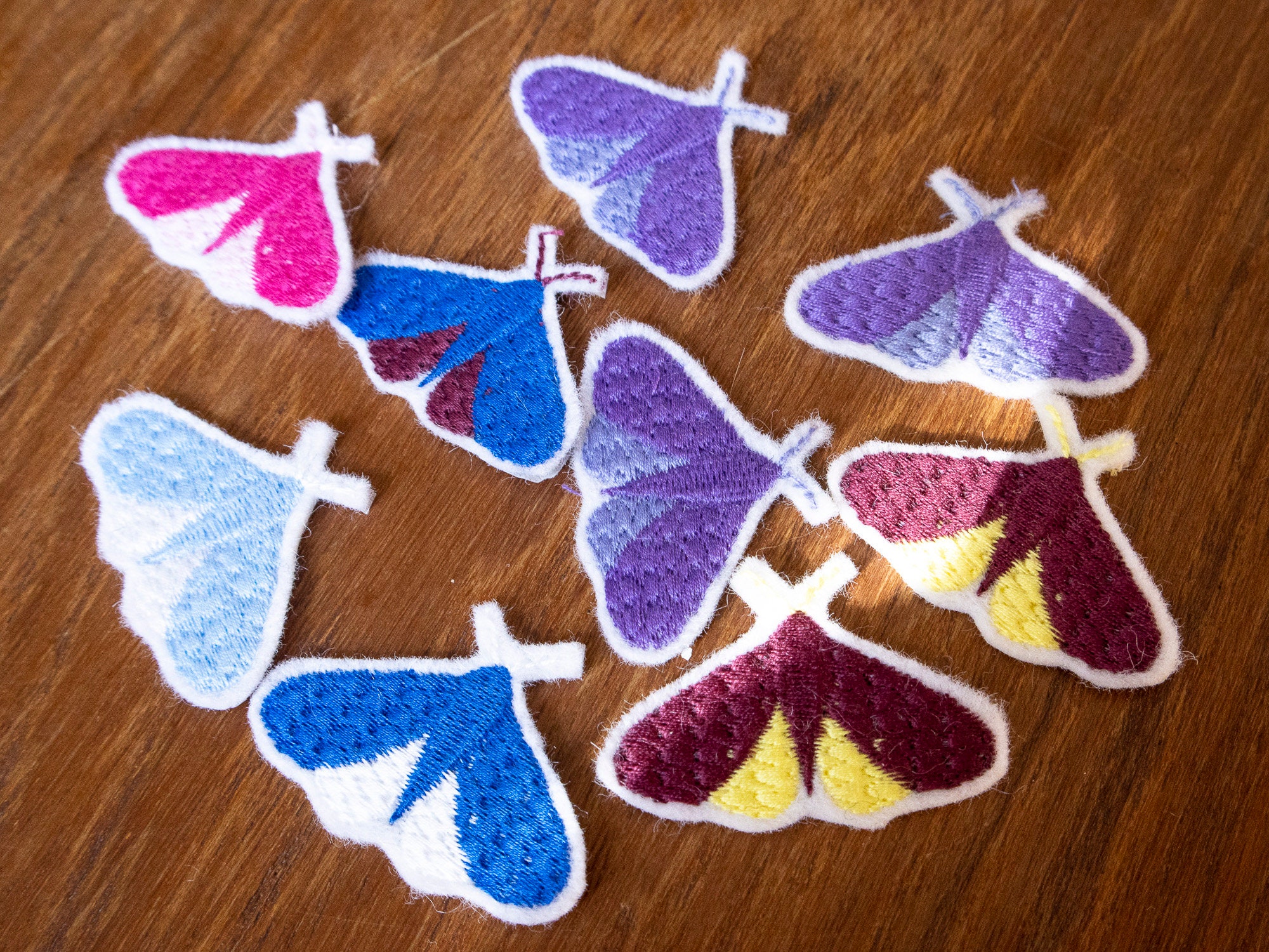 A close-up of a needle-felted moth hole repair patch blending seamlessly into a knitted sweater, showcasing intricate wool fibers and subtle color matching.