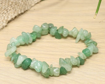 May include: A green gemstone chip bracelet made with small, irregular shaped chips of green aventurine. The bracelet is made with a stretchy cord and is approximately 7 inches in length.