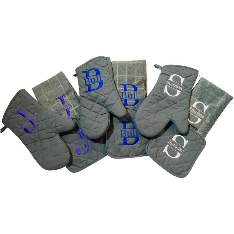 May include: Set of six gray quilted oven mitts and pot holders with embroidered names, including "Bull", "Sprouse", and "Jessic".