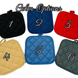 May include: Six quilted pot holders in different colors. The pot holders are numbered 1 through 6.  The colors are black, blue, red, beige, blue, and green.