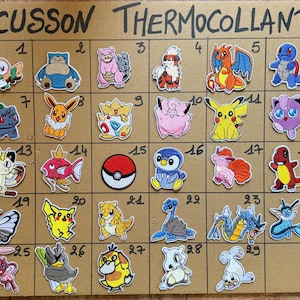 May include: A collection of thirty embroidered patches featuring various cartoon characters, including a red and white Poké Ball. The patches are arranged on a brown cardboard surface, with the text "ECUSSON THERMOCOLLANT" at the top.
