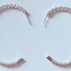 May include: A set of three ceramic mugs with a speckled, matte finish. The mugs are in shades of cream, light gray, and dark gray. Each mug has a simple, minimalist design and a rounded handle.