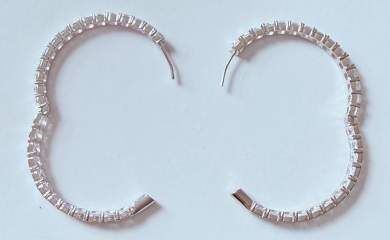 May include: A set of three ceramic mugs with a speckled, matte finish. The mugs are in shades of cream, light gray, and dark gray. Each mug has a simple, minimalist design and a rounded handle.