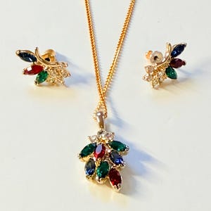 May include: A white ceramic mug with a wraparound design featuring a vibrant, colorful illustration of a toucan bird perched on a branch. The mug has a black handle and a glossy finish.