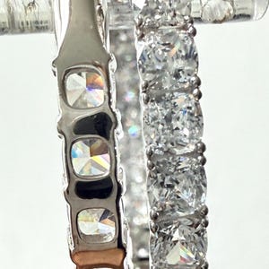 May include: A set of three ceramic mugs with a speckled, matte finish. The mugs are in shades of cream, light gray, and dark gray. Each mug has a simple, minimalist design, perfect for coffee or tea.