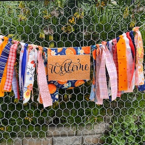 Orange and blue reversible birthday and welcome banner.