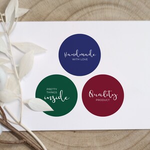 May include: Three round stickers with white text on a white background. The stickers are navy blue, green, and burgundy. The navy blue sticker says "Handmade with Love". The green sticker says "Pretty Things Inside". The burgundy sticker says "Quality Product".