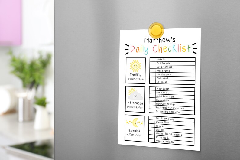 May include: A white daily checklist for Matthew, held by a yellow magnet on a gray refrigerator. The checklist includes morning, afternoon, and evening tasks, with colorful illustrations of a sun, cloud, and moon.